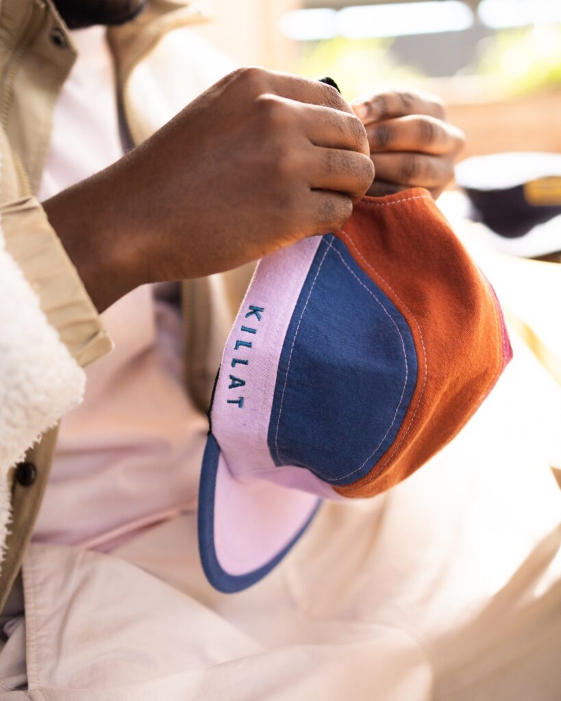Guy holding the bluebird x killat cap