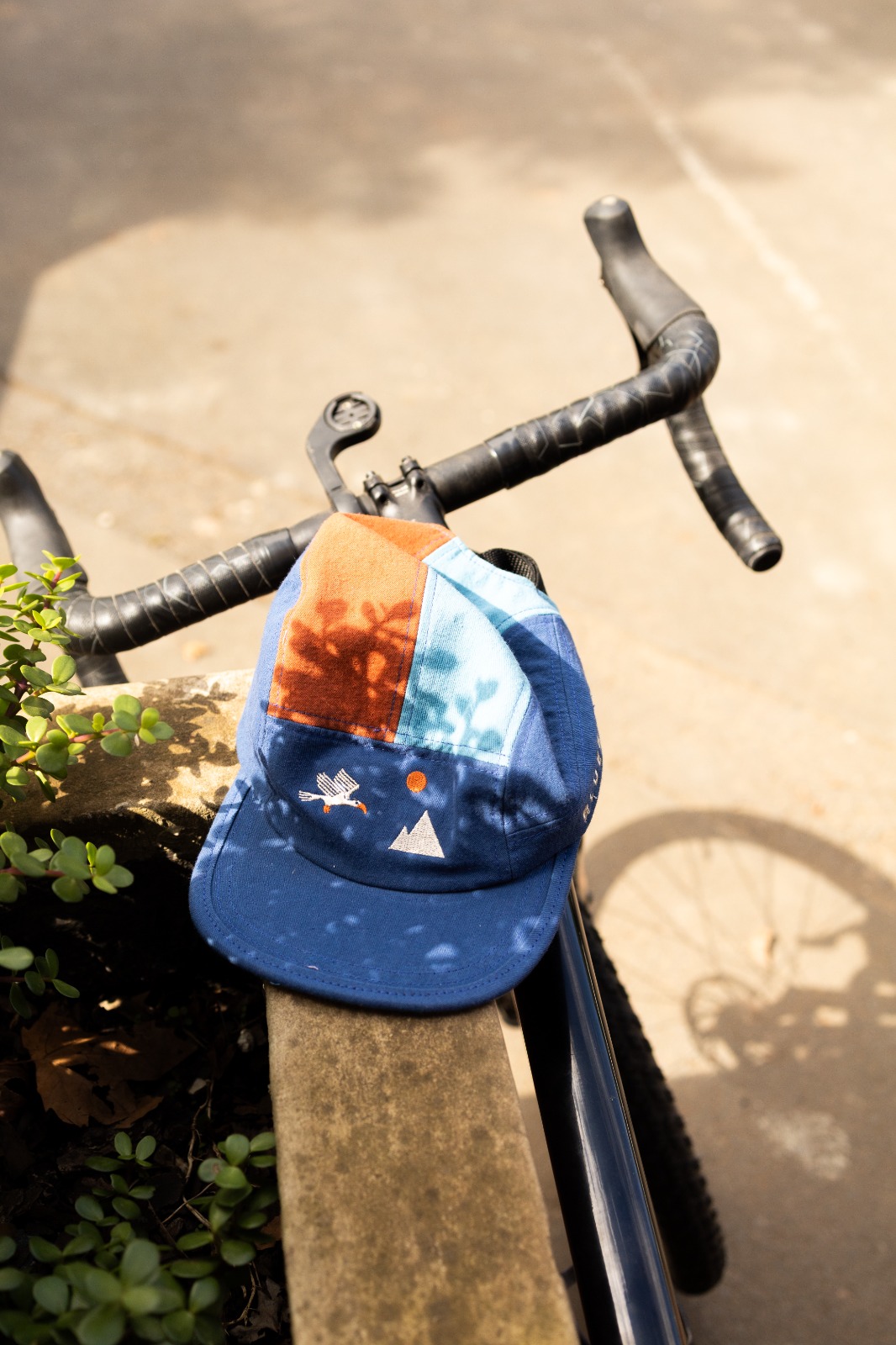 Bluebird x Killat cap A Bluebird Roastery x Killat cap on a road bike